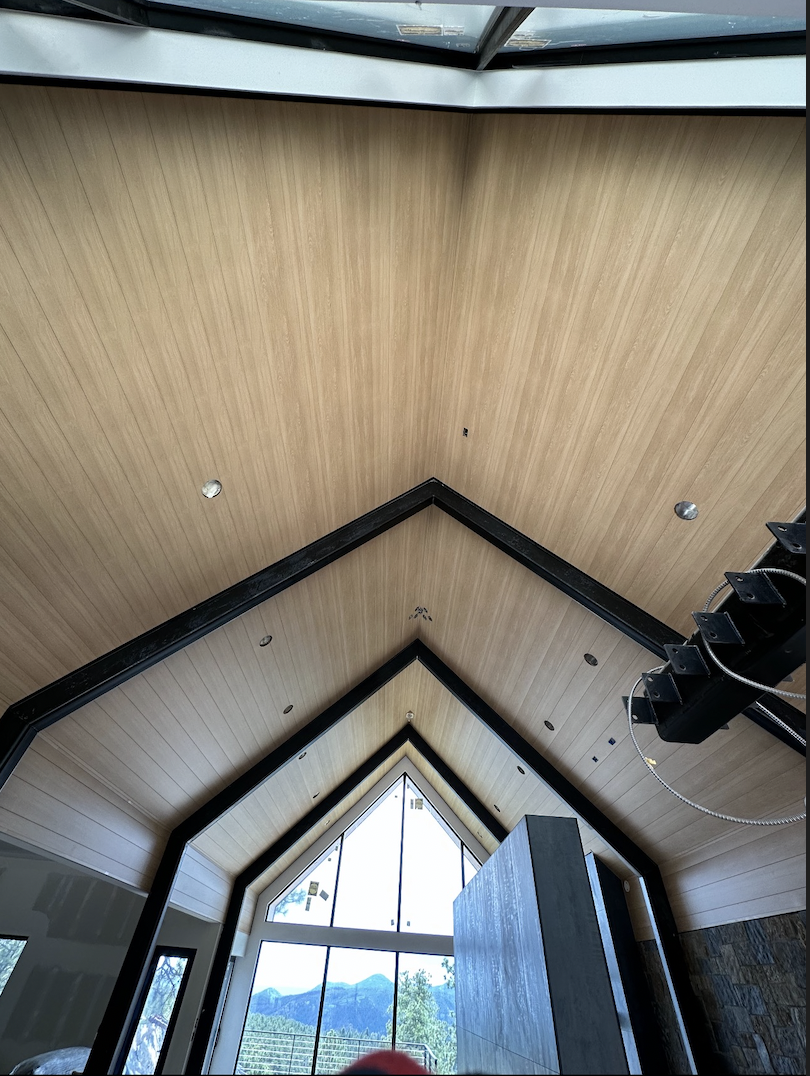 Interior vaulted ceiling with seamless metal soffit installation