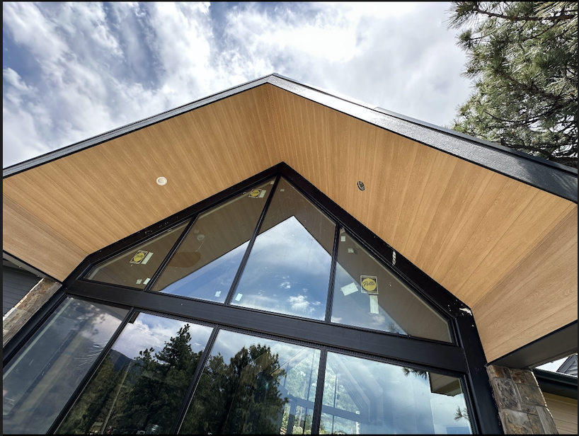 Front entrance showcasing premium metal soffit with wood-grain texture