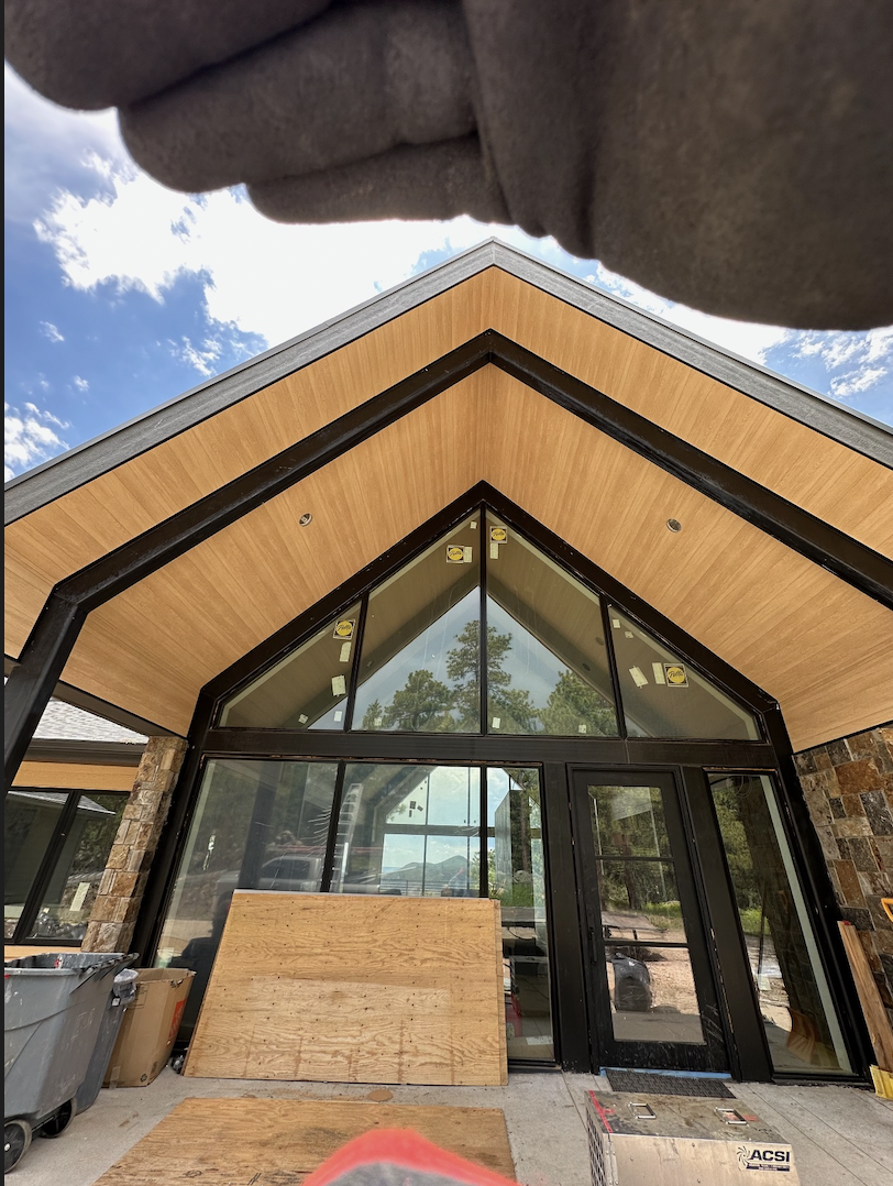 Detailed gabled roofline showing precision metal soffit with integrated lighting